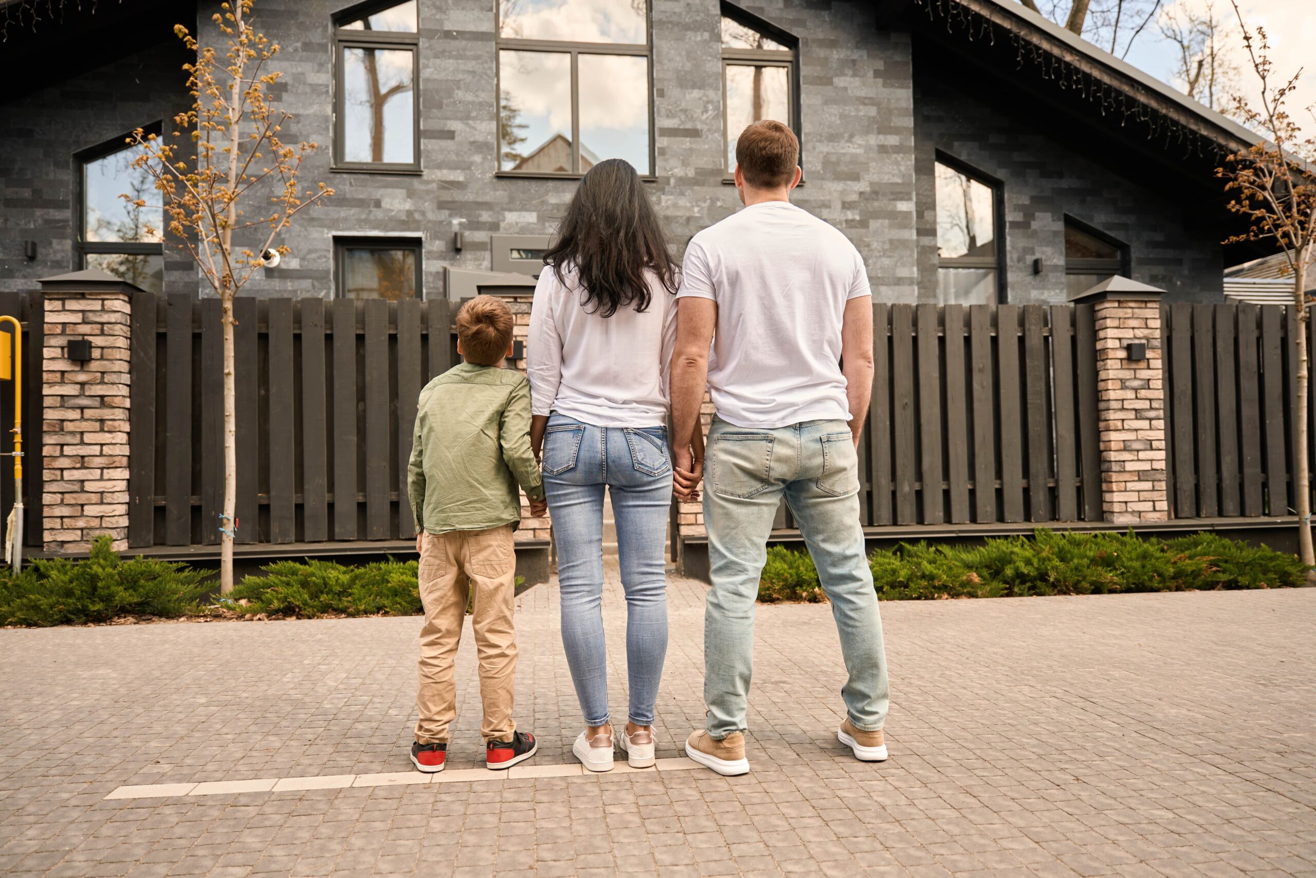 Worried family outside their home facing foreclosure.